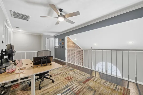 a workspace with wooden floor and furniture