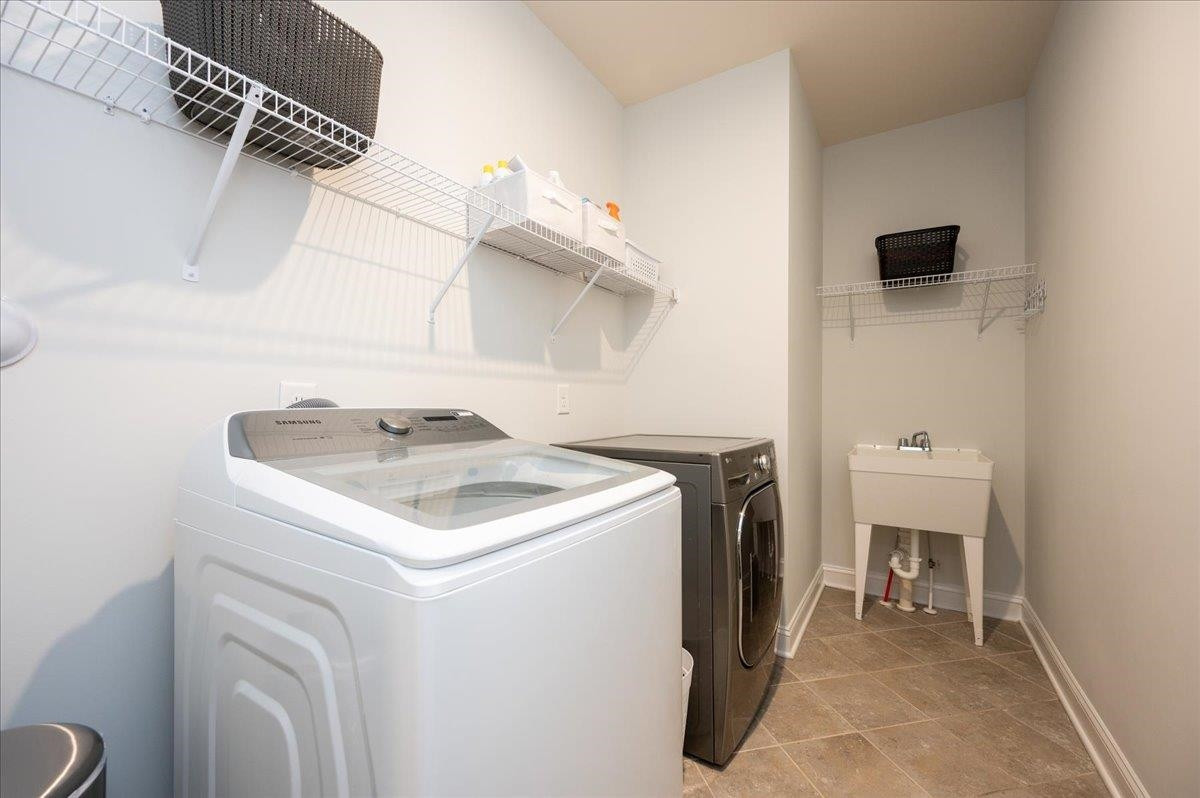 7108 Rex Road Holly Springs, NC 27540 - Photo 28 of 38 This massive laundry room on the main level also features a working sink! Laundry Room