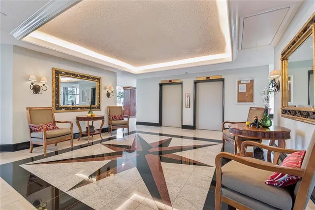 a living room with a mirror and a chandelier