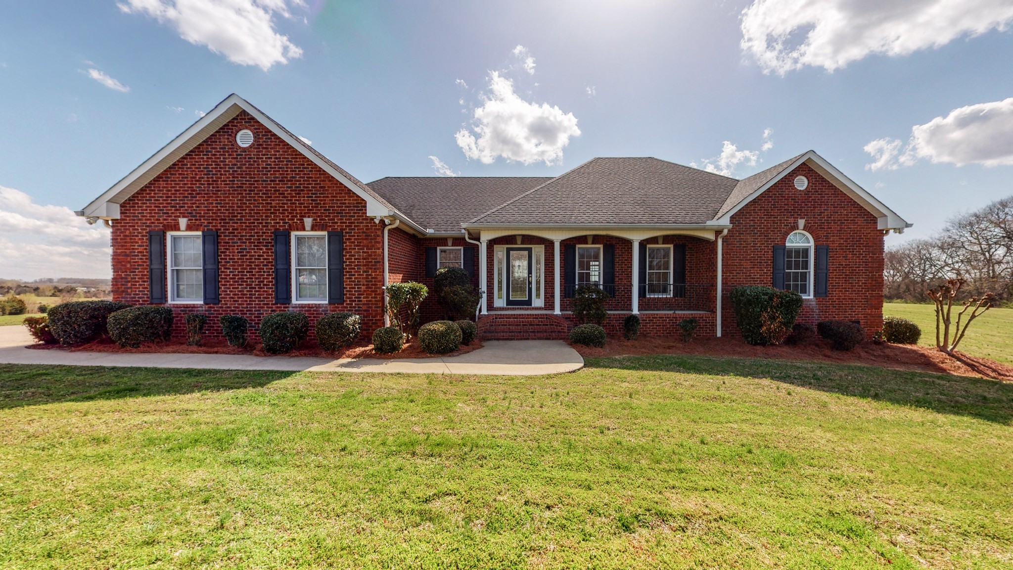 a front view of a house with swimming pool and porch