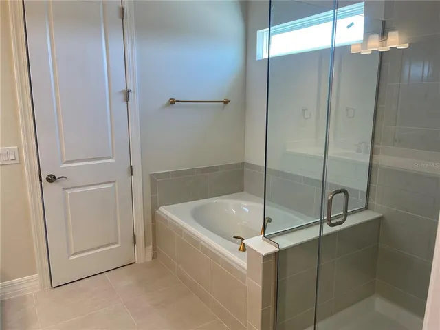 a bathroom with a tub and shower