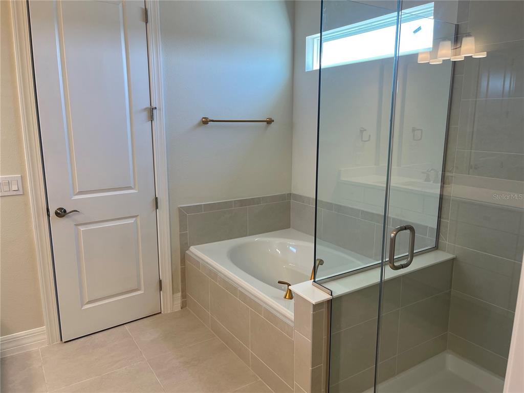 8375 Fenton Street Orlando, FL 32836 - Photo 20 of 29 a bathroom with a tub and shower