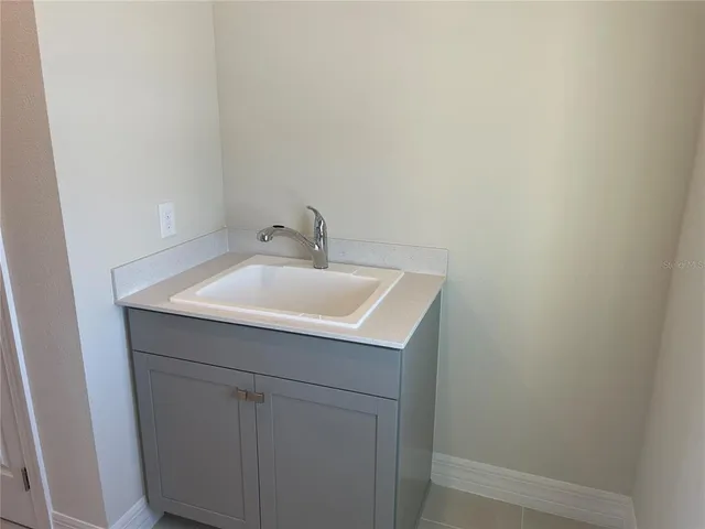 a bathroom with a sink and mirror