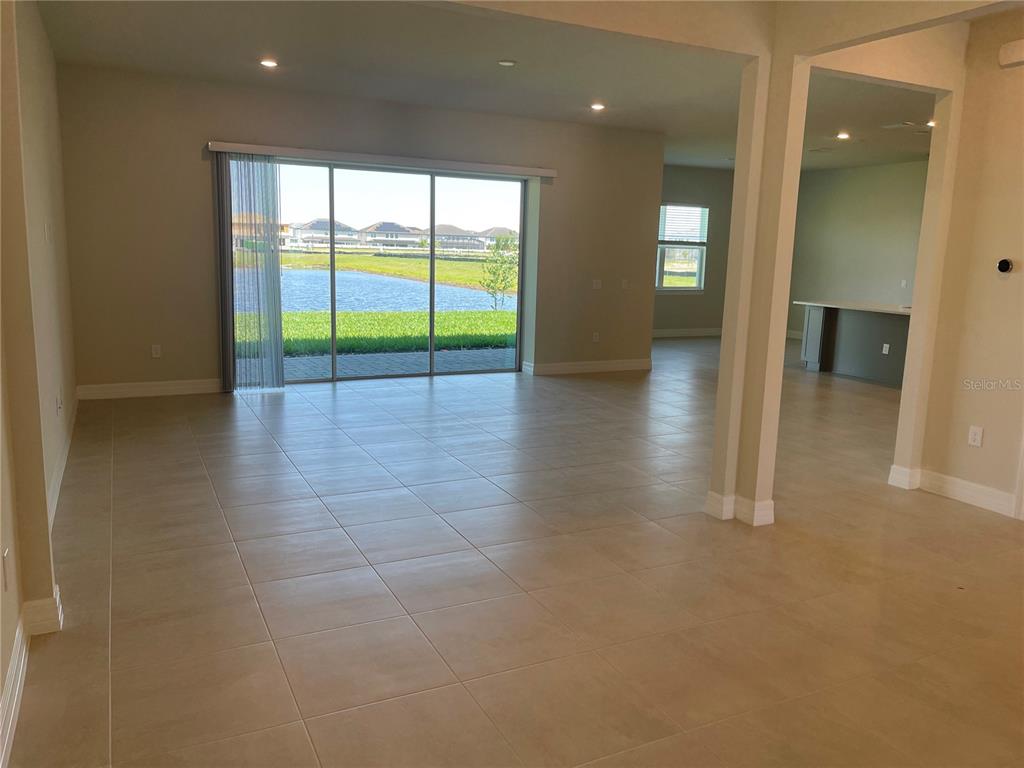 8375 Fenton Street Orlando, FL 32836 - Photo 4 of 29 an empty room with floor to ceiling window and an outdoor view