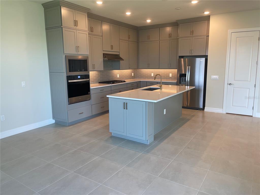 8375 Fenton Street Orlando, FL 32836 - Photo 6 of 29 a kitchen with stainless steel appliances granite countertop a stove a refrigerator and a oven