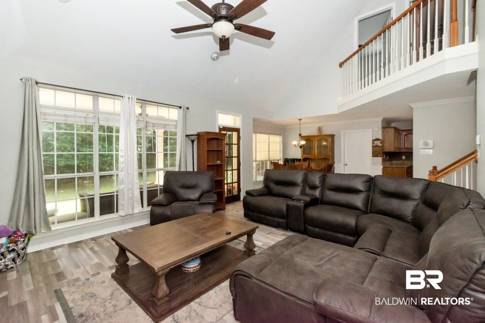 9991 Wedgefield Court Mobile, AL 36608 - Photo 3 of 30 Living room featuring ceiling fan, light wood-type flooring, and a high ceiling