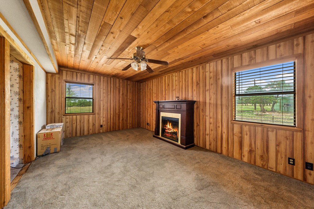 3526 Stapp Ranch Road Harper, TX 78631 - Photo 9 of 30 a view of an empty room with windows and a fireplace