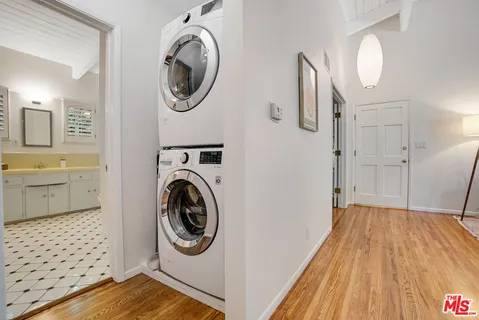 a view of a storage and utility room with washer and dryer