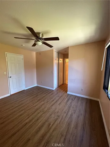 a view of an empty room and wooden floor