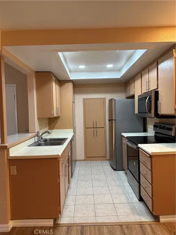 a kitchen with stainless steel appliances granite countertop a sink and a stove