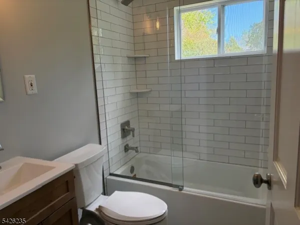 a bathroom with a toilet and shower