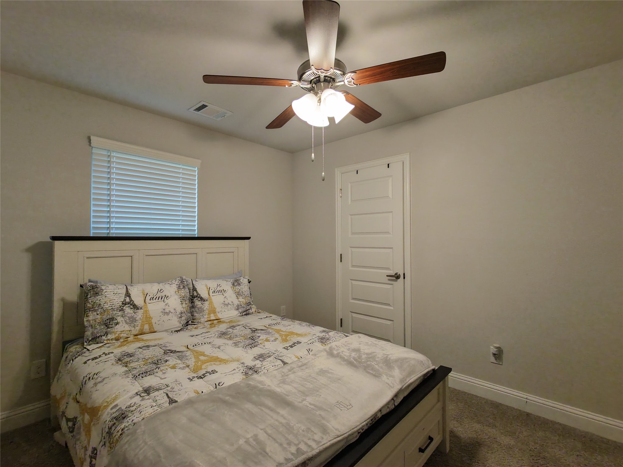 10142 Whitney Reach Drive Rosharon, TX 77583 - Photo 16 of 26 a bedroom with a bed and a chandelier