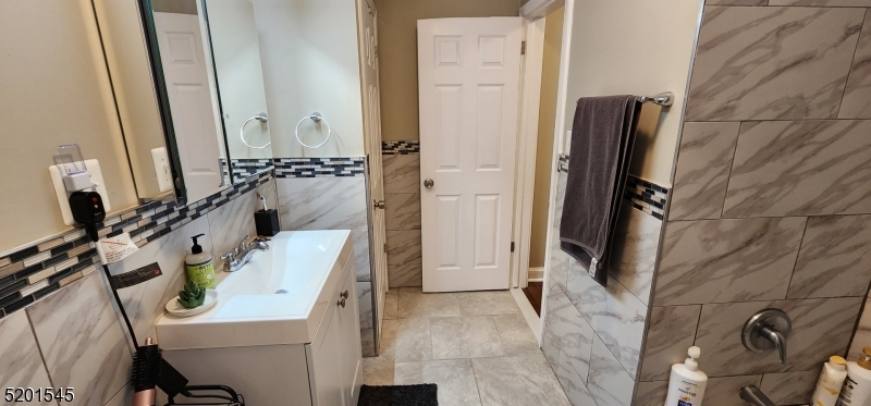 46 Cumberland Avenue, Unit 2 Verona, NJ 07044 - Photo 13 of 25 a bathroom with a sink and a mirror