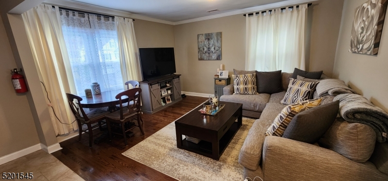 46 Cumberland Avenue, Unit 2 Verona, NJ 07044 - Photo 2 of 25 a living room with furniture and a flat screen tv