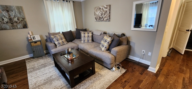 46 Cumberland Avenue, Unit 2 Verona, NJ 07044 - Photo 3 of 25 a living room with furniture and a flat screen tv