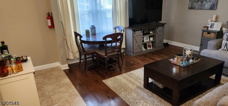 46 Cumberland Avenue, Unit 2 Verona, NJ 07044 - Photo 5 of 25 a living room with furniture and a flat screen tv