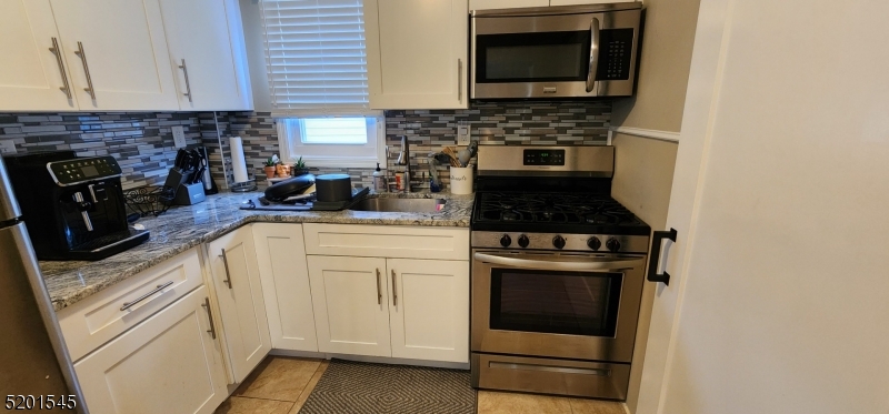 46 Cumberland Avenue, Unit 2 Verona, NJ 07044 - Photo 6 of 25 a kitchen with cabinets and appliances