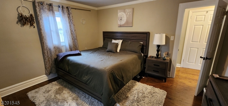 46 Cumberland Avenue, Unit 2 Verona, NJ 07044 - Photo 7 of 25 a bedroom with a bed and a mirror on the dresser