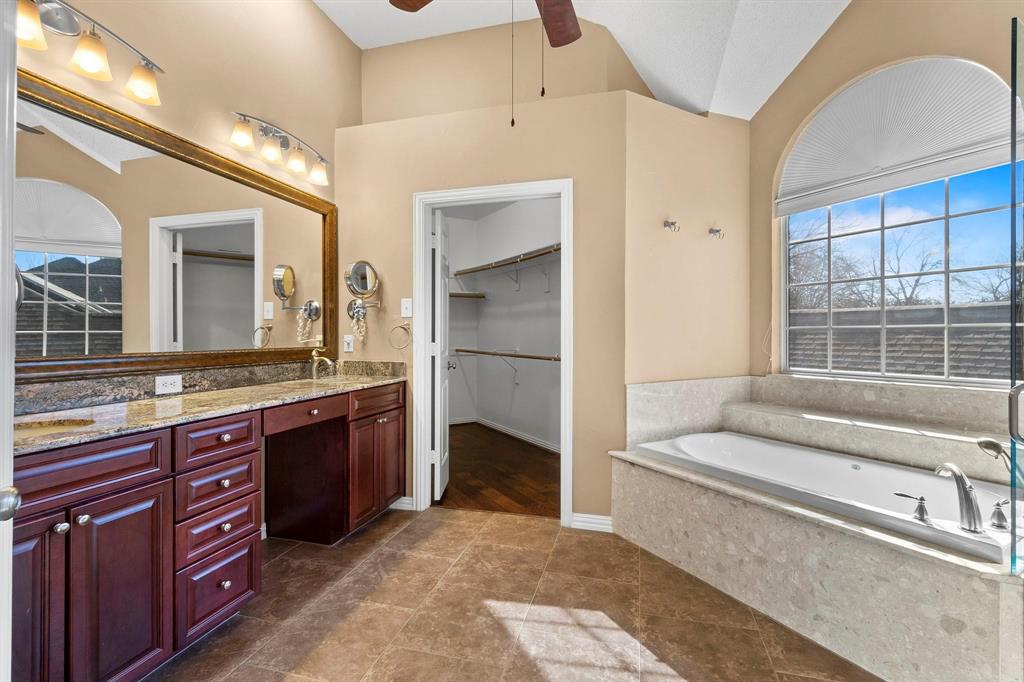 14588 Poe Court Addison, TX 75001 - Photo 18 of 28 a spacious bathroom with a granite countertop sink and a large mirror