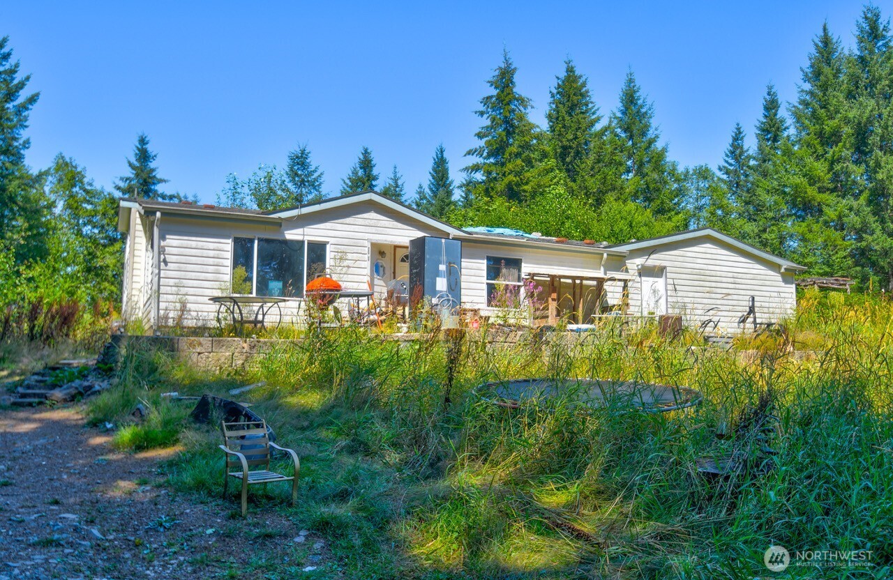 305 August Road, Unit 75 Onalaska, WA 98570 - Photo 6 of 21 a view of a house with a yard and potted plants