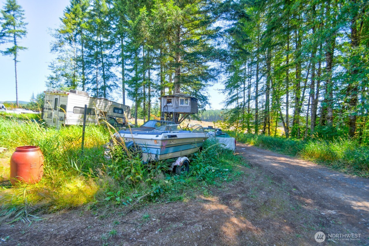305 August Road, Unit 75 Onalaska, WA 98570 - Photo 7 of 21 a backyard of a house with table and chairs