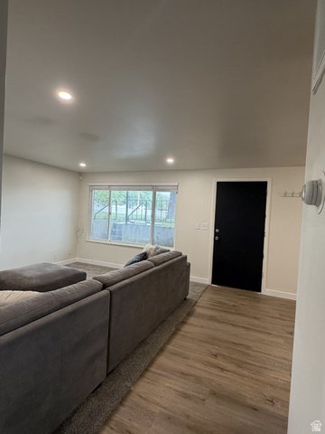 895 East Arrowhead Lane Murray, UT 84107 - Photo 10 of 12 Spacious living area featuring recessed lighting, a large window with roller shades, and wood-finish flooring