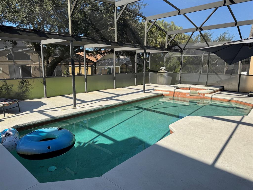 8449 Secret Key Cove Kissimmee, FL 34747 - Photo 3 of 3 a swimming pool with an outdoor seating yard and barbeque oven