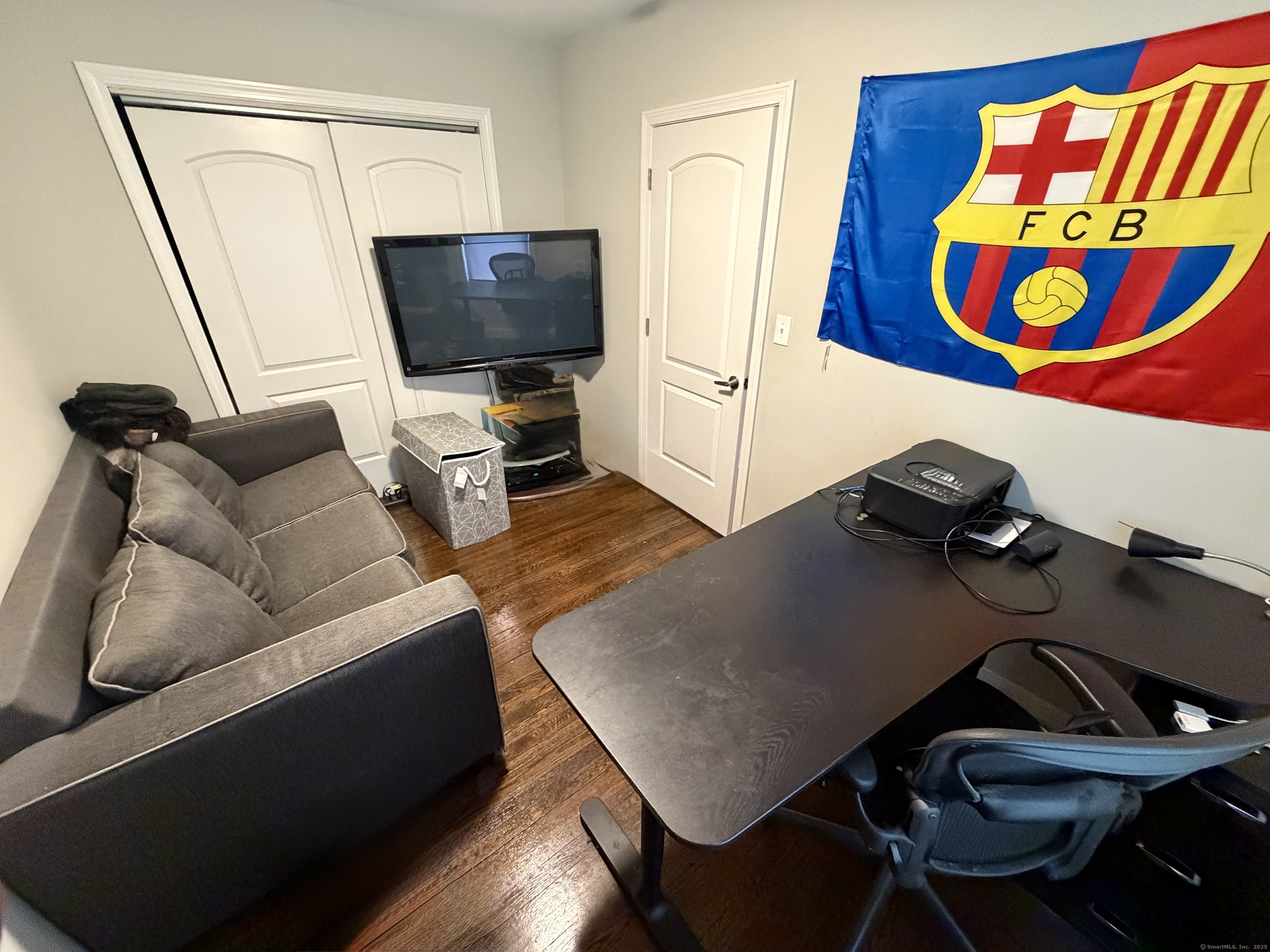 26 Grove Street Trumbull, CT 06611 - Photo 15 of 38 a living room with furniture and a flat screen tv