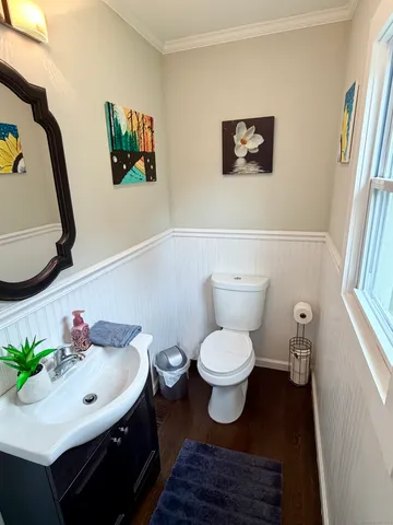 a bathroom with a toilet a sink and a mirror