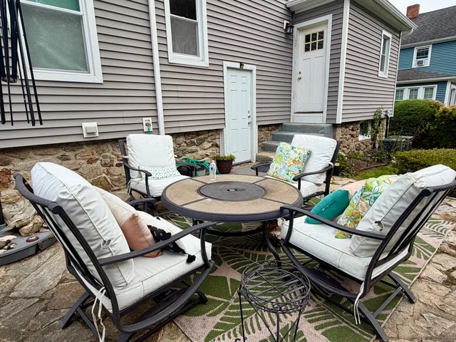 a view of a patio with couple of chairs and a couch