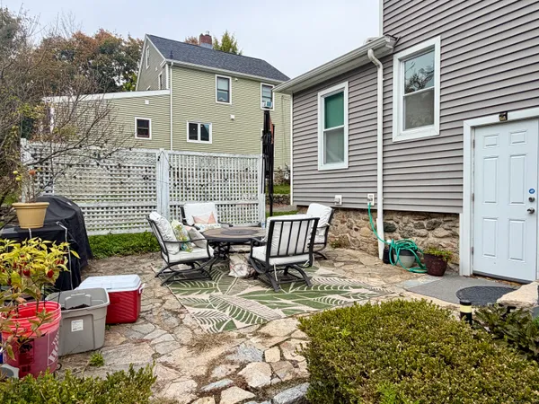 a backyard of a house with outdoor seating