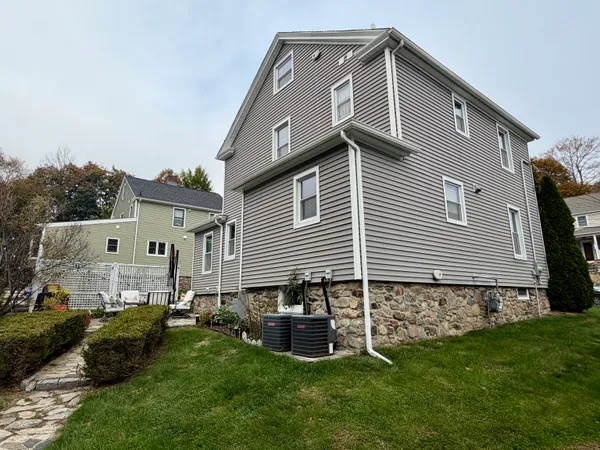 a front view of a house with a garden and yard