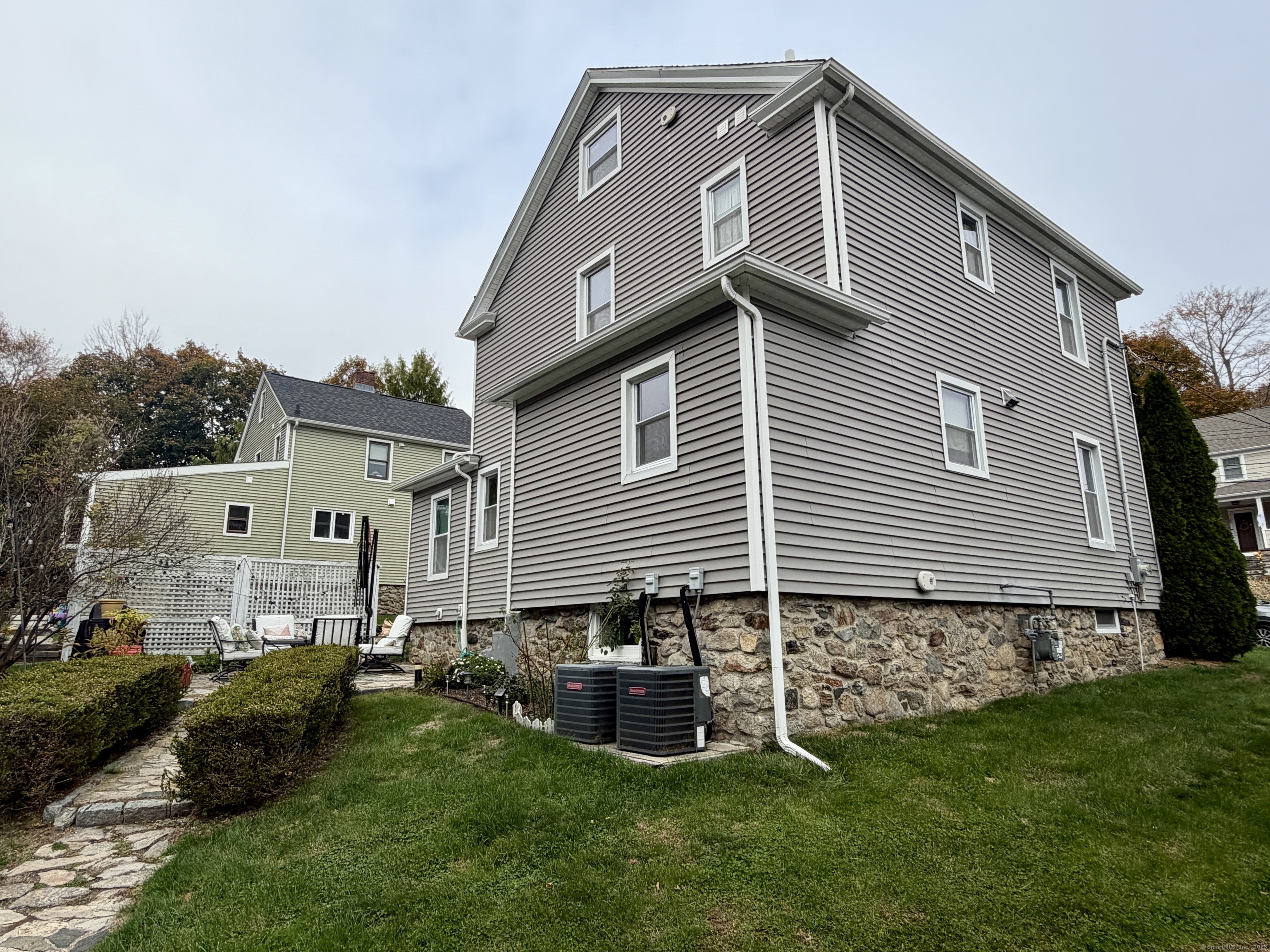 26 Grove Street Trumbull, CT 06611 - Photo 32 of 38 a front view of a house with a garden and yard