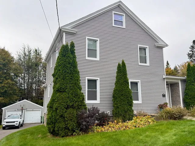 a view of a house with a yard and plants