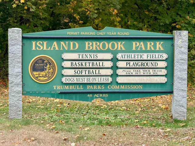 a sign that is sitting on a wooden wall