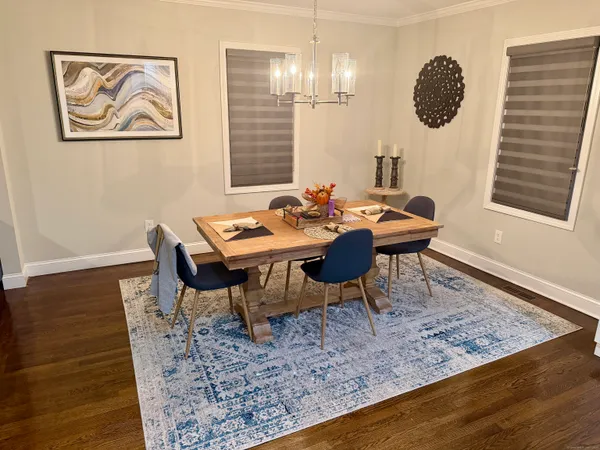 a dining room with furniture and wooden floor