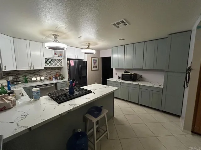 a kitchen with a sink cabinets and stainless steel appliances