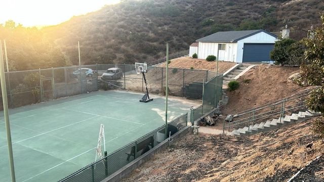 a balcony with a table and chairs under an umbrella
