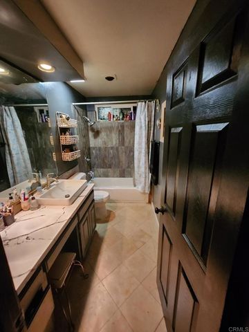a bathroom with a sink a large mirror and a shower