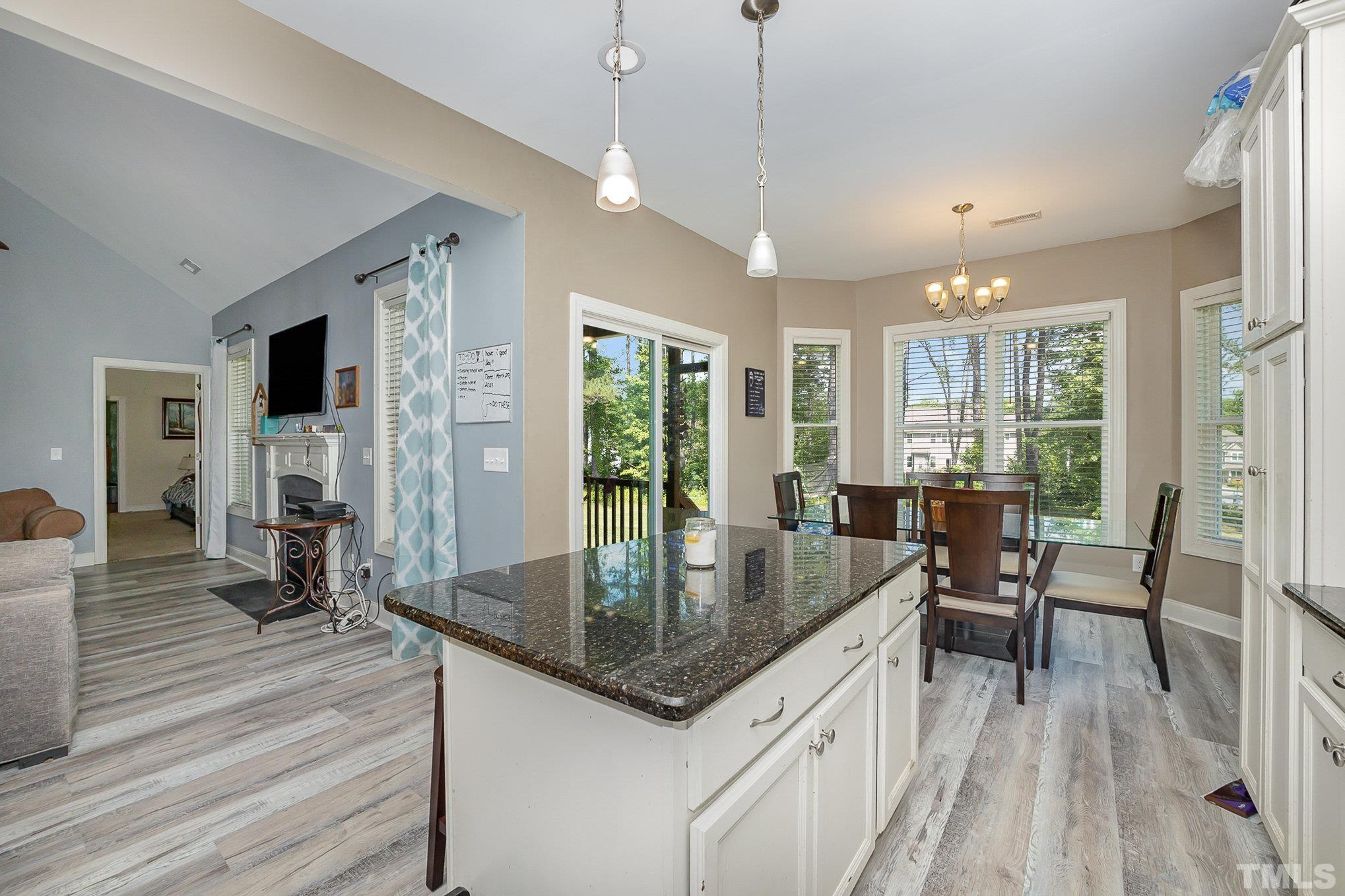 16 Chaparral Trail Garner, NC 27529 - Photo 11 of 29 a kitchen with center island wooden floor center island and stainless steel appliances