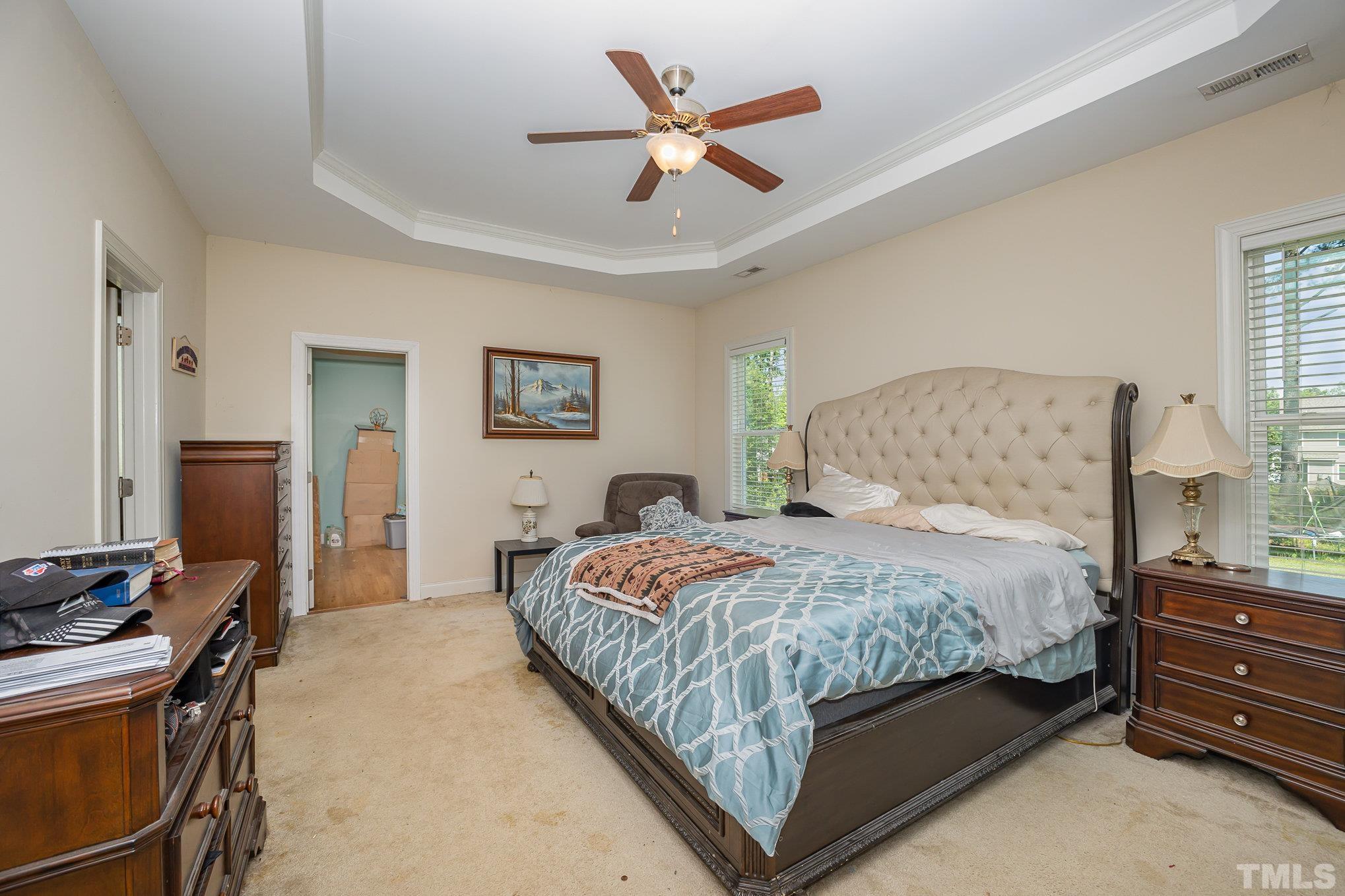 16 Chaparral Trail Garner, NC 27529 - Photo 13 of 29 a bedroom with a bed and a chandelier