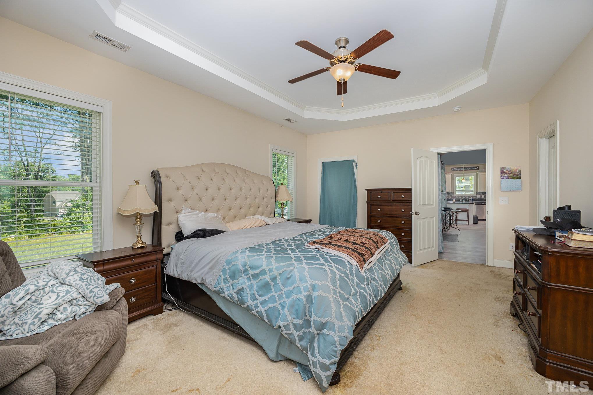 16 Chaparral Trail Garner, NC 27529 - Photo 14 of 29 a bedroom with a bed a couch and a large window