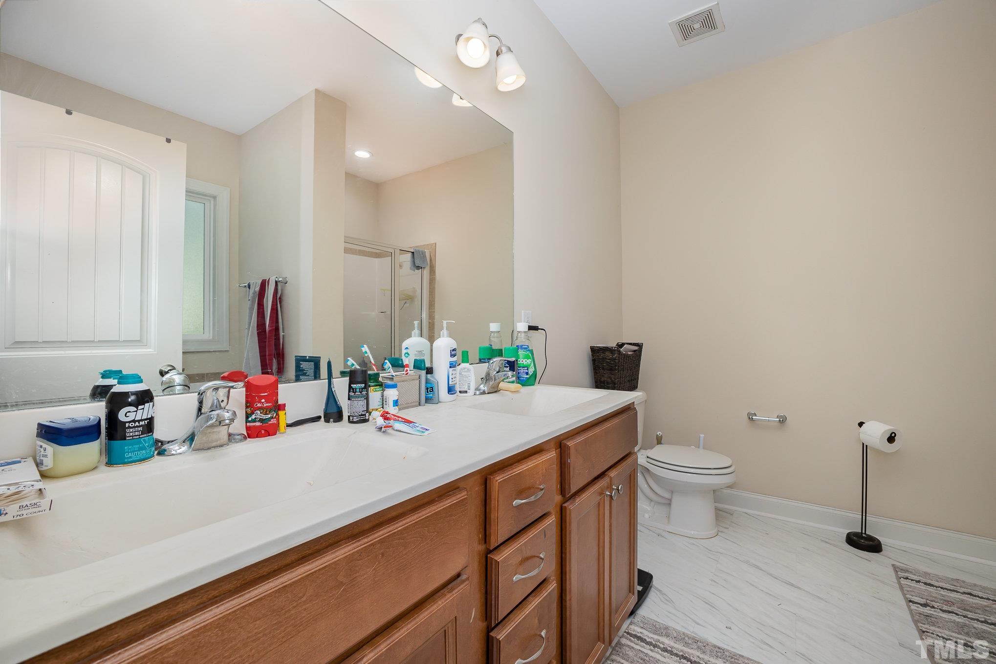 16 Chaparral Trail Garner, NC 27529 - Photo 15 of 29 a bathroom with a sink a toilet and a mirror