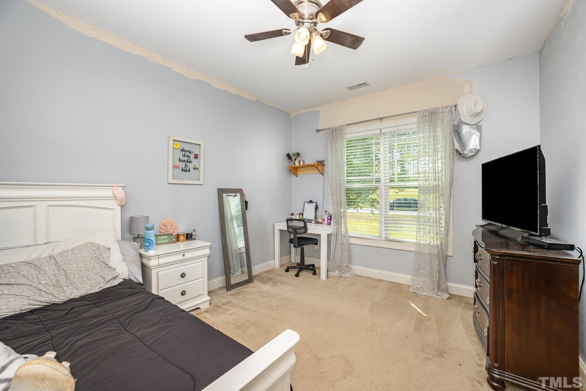 16 Chaparral Trail Garner, NC 27529 - Photo 18 of 29 a bedroom with furniture and a flat screen tv