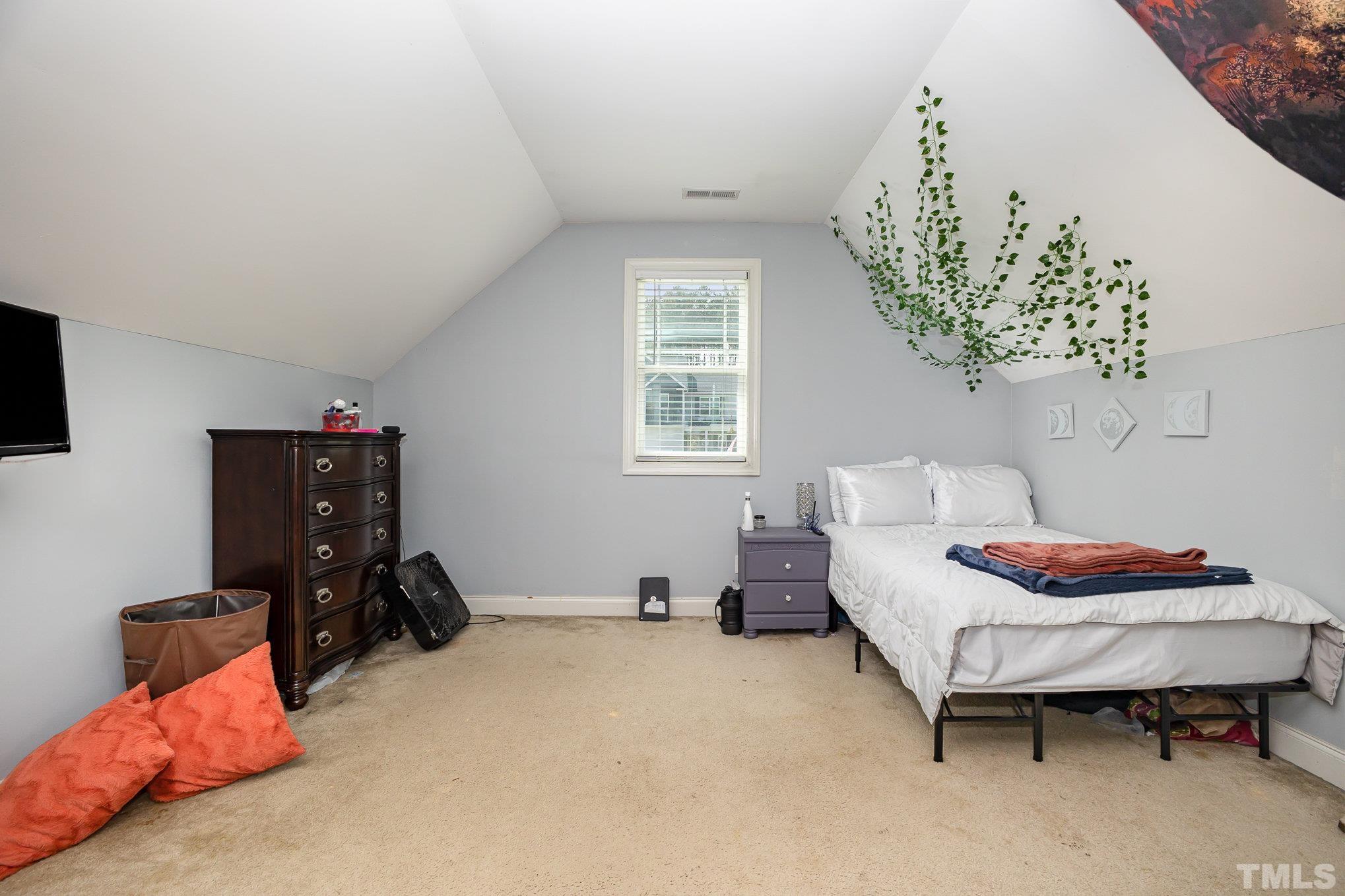 16 Chaparral Trail Garner, NC 27529 - Photo 19 of 29 a bedroom with a bed and a window