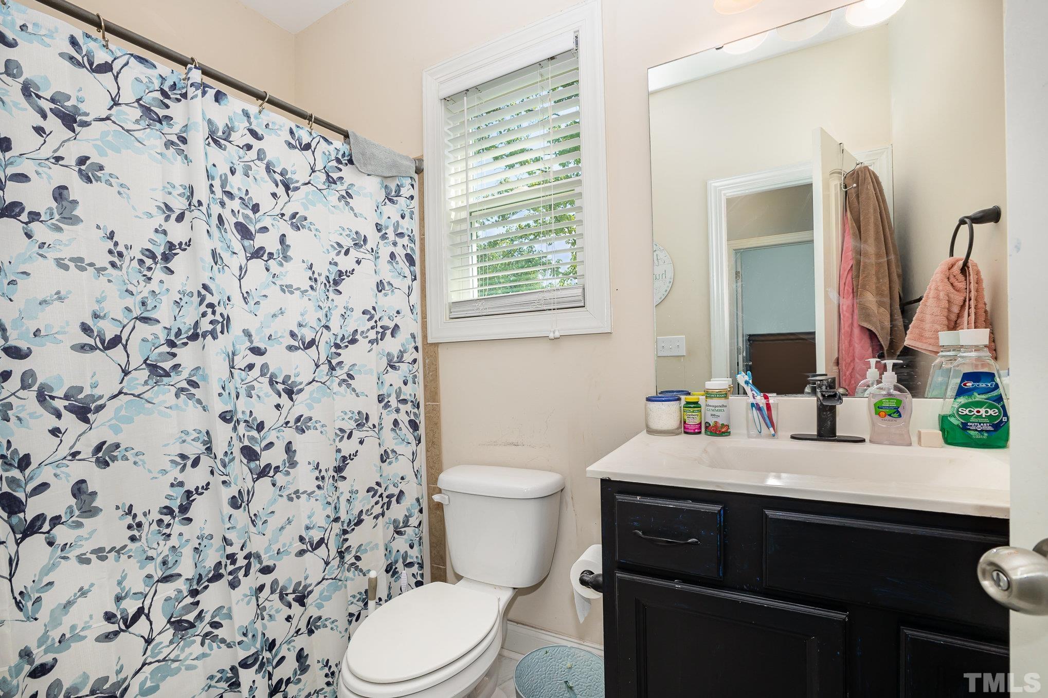 16 Chaparral Trail Garner, NC 27529 - Photo 21 of 29 a bathroom with a sink toilet and mirror