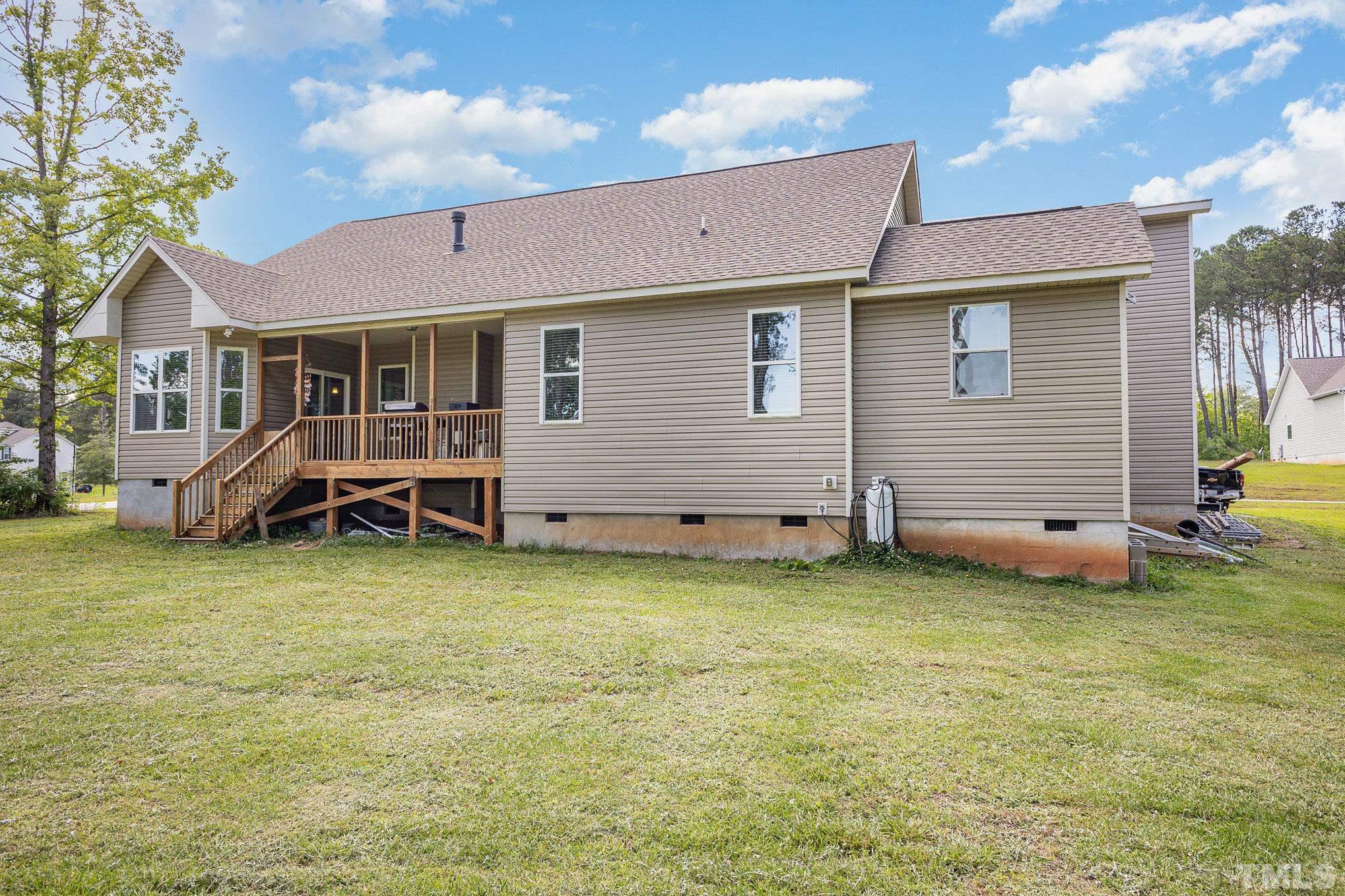 16 Chaparral Trail Garner, NC 27529 - Photo 28 of 29 a backyard of a house with table and chairs