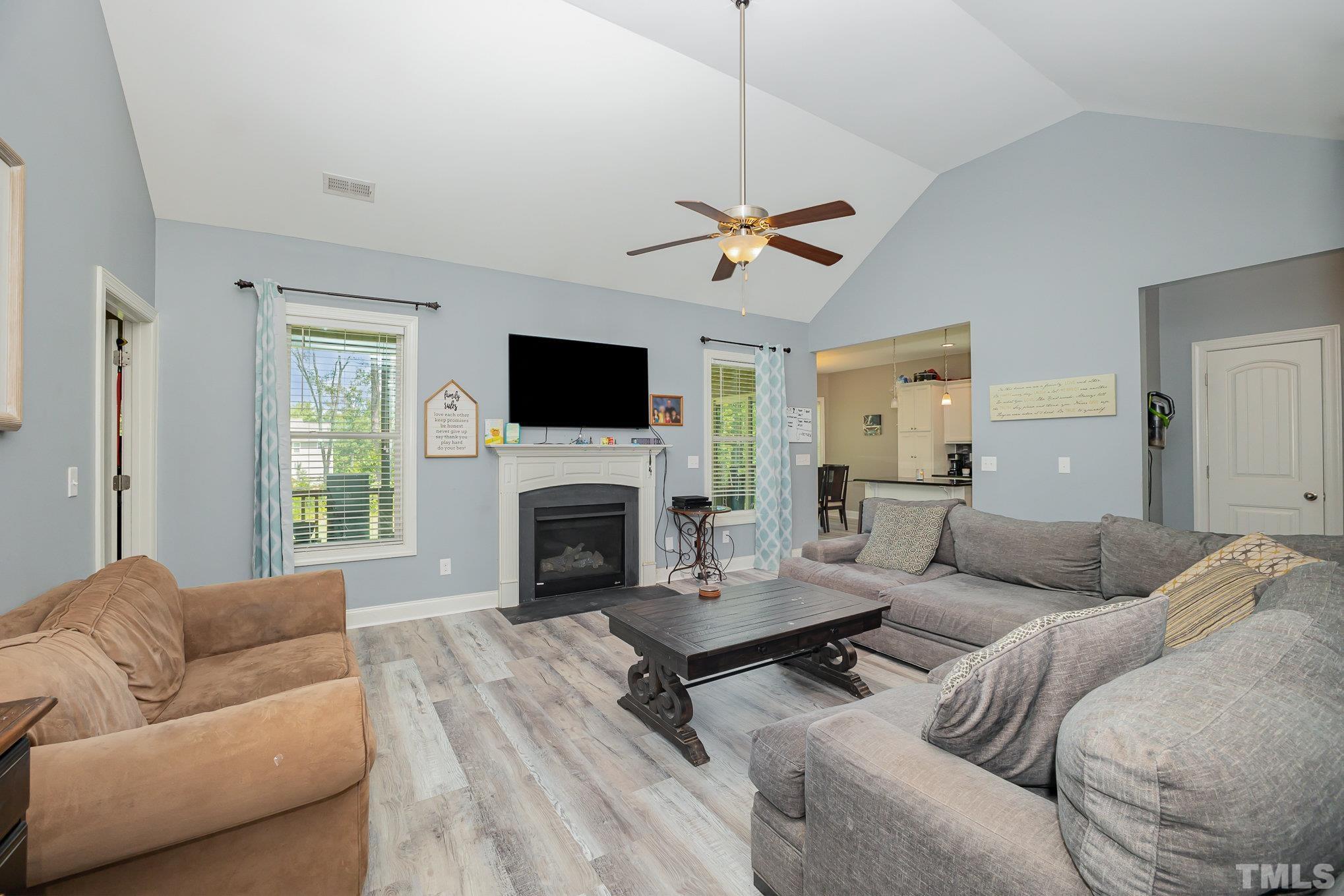 16 Chaparral Trail Garner, NC 27529 - Photo 8 of 29 a living room with furniture a flat screen tv and a window