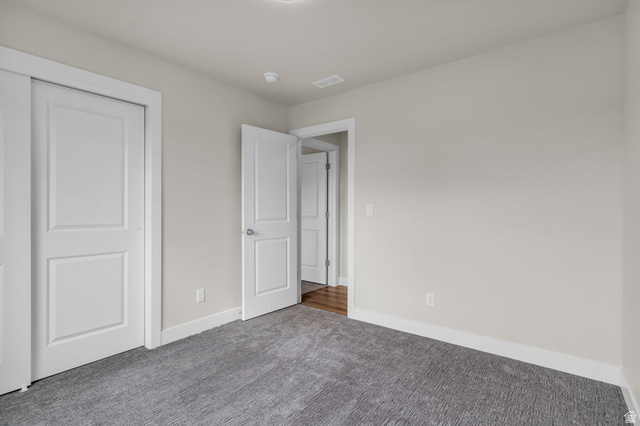 576 7th Avenue Midvale, UT 84047 - Photo 22 of 32 Unfurnished bedroom featuring carpet flooring and a closet