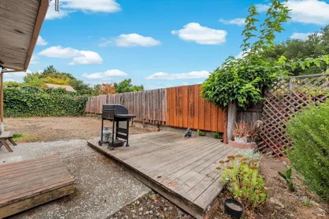 a wooden bench sitting in the middle of a backyard